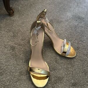 Brand new, shiny gold metallic heels with an ankle strap